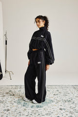 Jogginghose mit weitem Bein und Crinkle-Nylon-Paspelierung – Schwarz