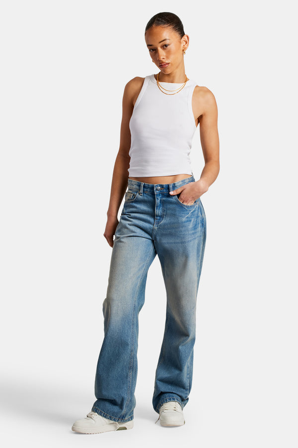 Female Model wearing mid rise relaxed jeans in an antique wash clolour