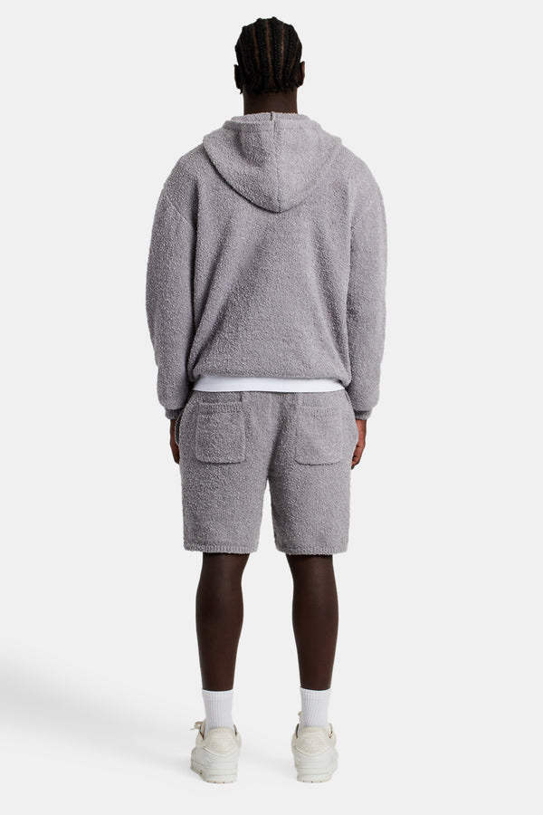 Male model wearing the Textured Knitted Hooded Short Tracksuit in grey