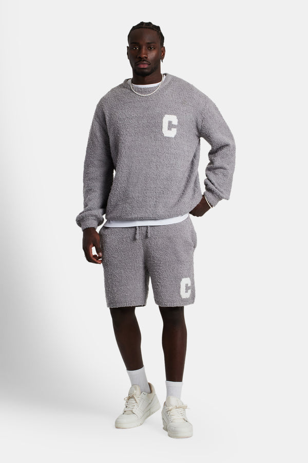 Male model wearing the Textured Knitted Sweatshirt Short Tracksuit in grey