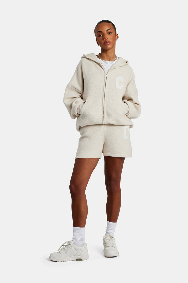 female model wearing the Hooded Zip Through Knitted Short Tracksuit in oatmeal