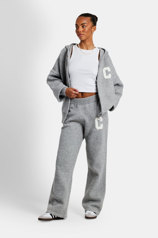 female model wearing the hooded zip through knitted jumper in grey