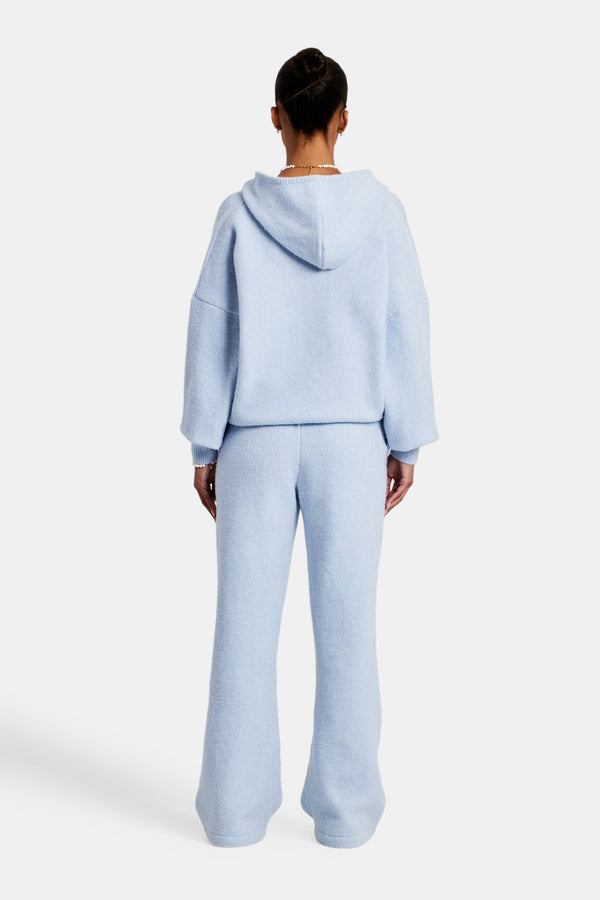 Female Model wearing hooded zip through knitted tracksuit in light blue