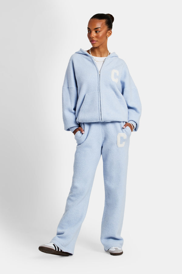 Female Model wearing hooded zip through knitted tracksuit in light blue 