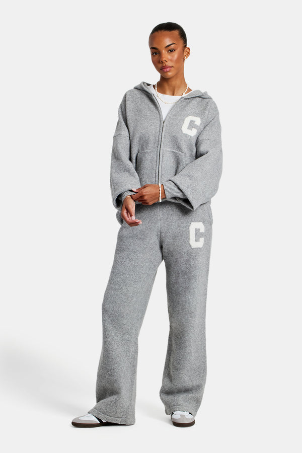 female model wearing the hodded zip through knitted tracksuit in grey