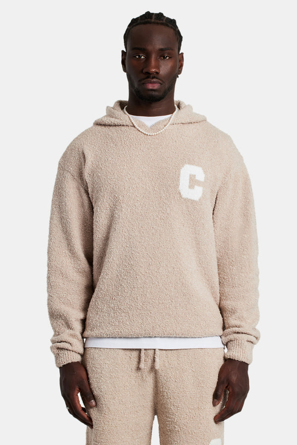 Male model wearing the Textured Knitted Hoodie in Beige