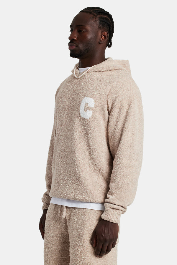 Male model wearing the Textured Knitted Hoodie in Beige
