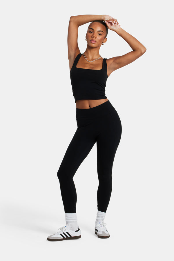 Female model wearing the deep waistband leggings in black