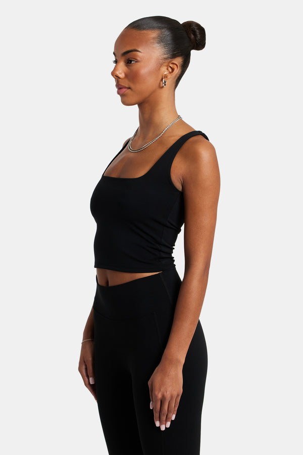Female model wearing the square neck top in black