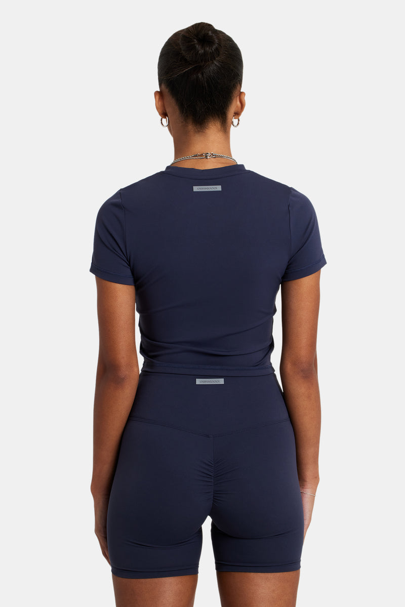 Female model wearing the fitted seam detail t-shirt in Navy