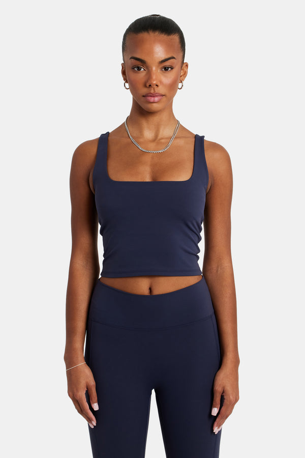 Female model wearing the square Neck top in navy