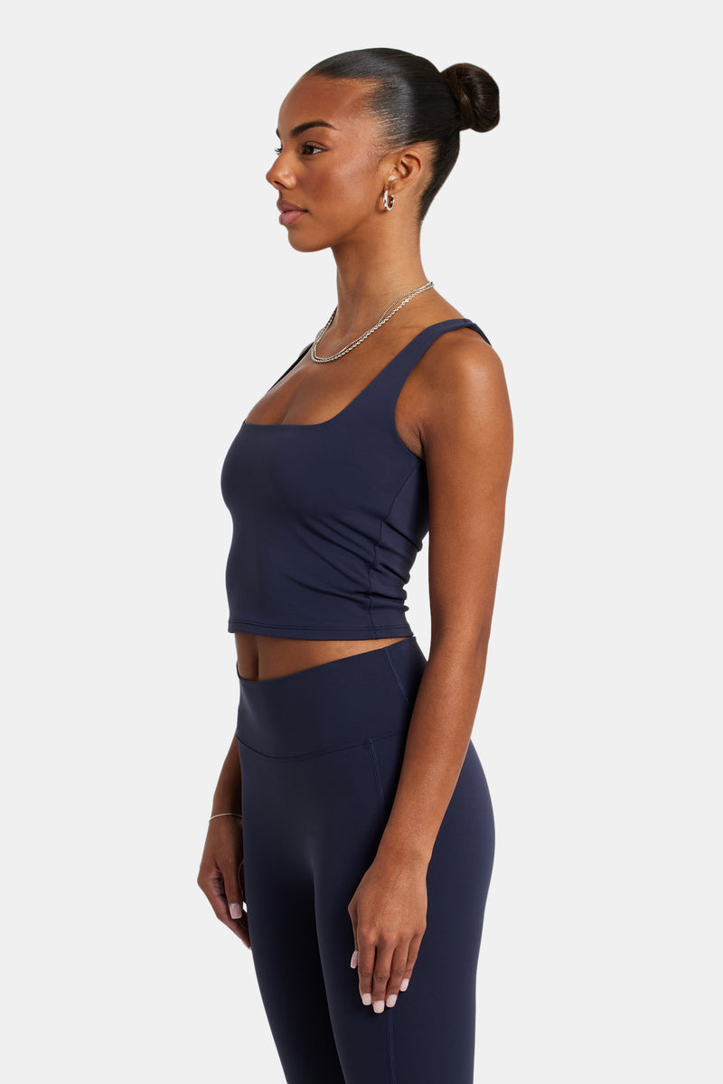 Female model wearing the square Neck top in navy