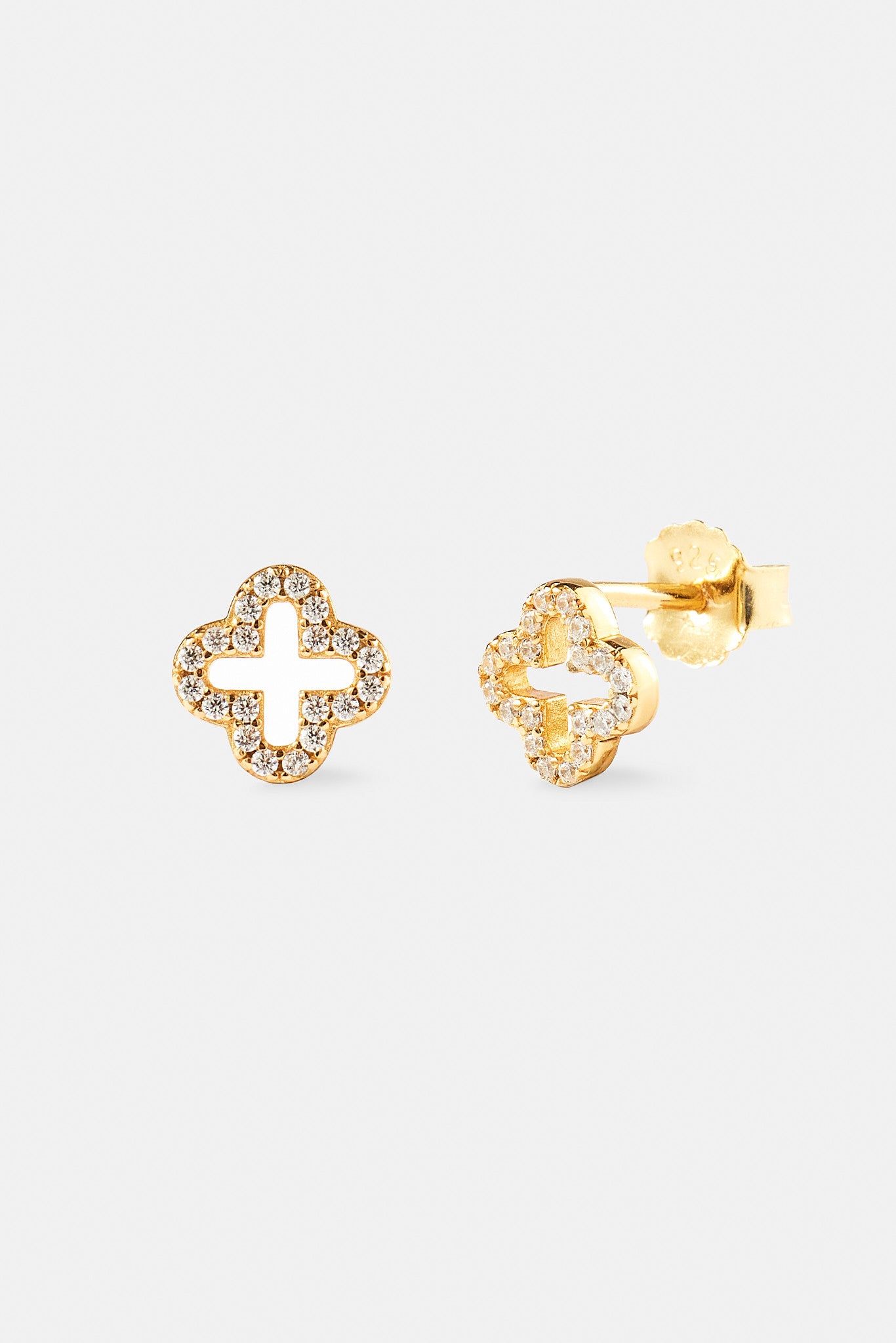 Gold earrings with diamond-like stones on a white background