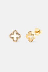 Gold earrings with diamond-like stones on a white background