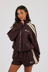 Buttergelbe Trainingsjacke mit Trichterhalsausschnitt und durchgehendem Reißverschluss - Schokolade