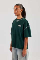 T-Shirt mit Diamantschnitt und Kontraststichen – Waldgrün