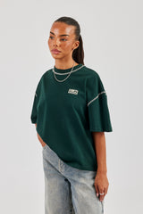 T-Shirt mit Diamantschnitt und Kontraststichen – Waldgrün