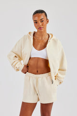 Kurzer Kapuzenpullover mit durchgehendem Reißverschluss und bestickter Shorts – Buttergelb