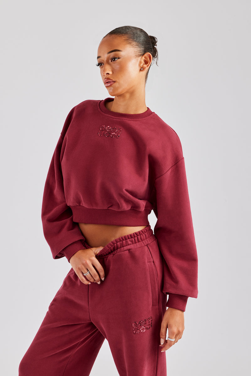 Kurzes Sweatshirt mit Glitzerapplikation - Kirschrot