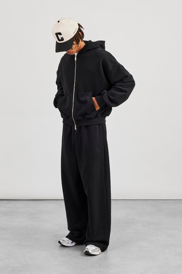 Kapuzenjacke mit Reißverschluss und Jogginghose im Baggy-Fit - Schwarz