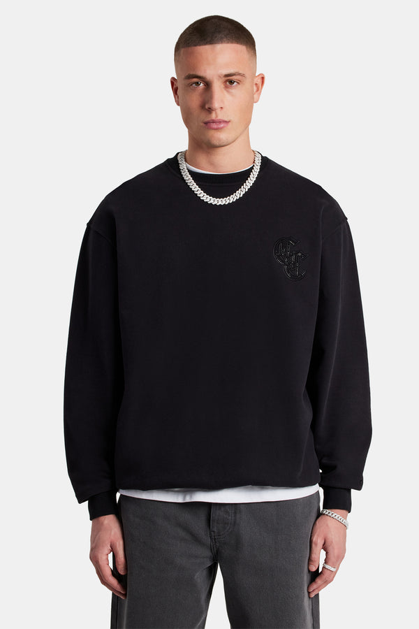 Male model wearing the gothic C rhinestone sweatshirt  in black 