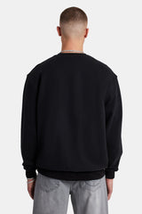 Male Model wearing black sweater with embellished C detail