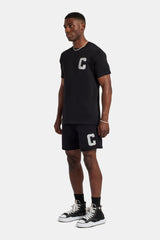 Set aus T-Shirt und Shorts mit C-Verzierung - Schwarz