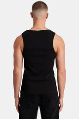 Man wearing black ribbed vest and showing the back 