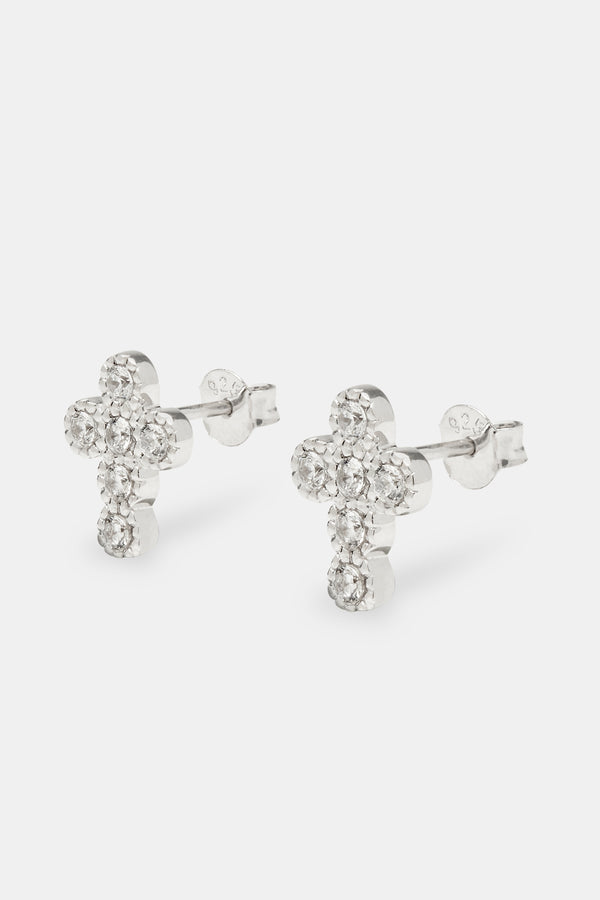 Iced cross stud earrings on white background