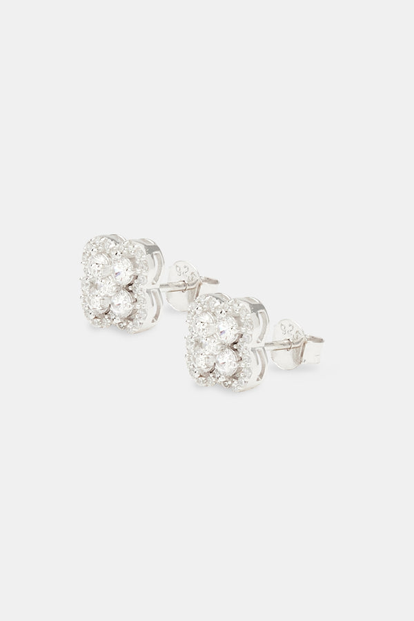 Iced floral motif stud earrings on white background