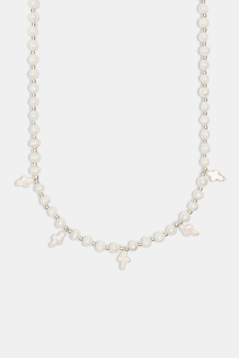 Freshwater pearl cross necklace on white background