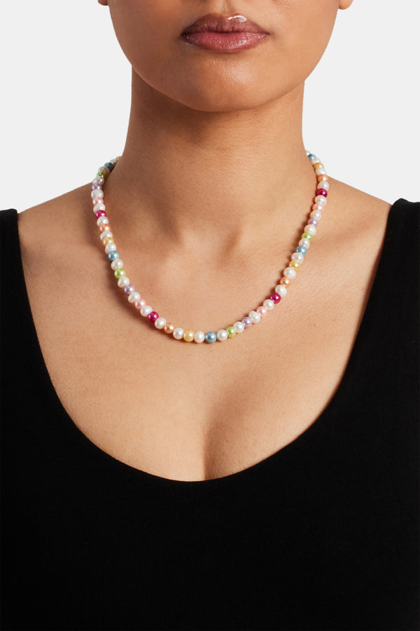 Female model wearing multicolour pearl necklace