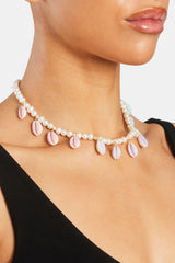 Female model wearing Freshwater Pearl Pastel Cowrie Shell Necklace in gold