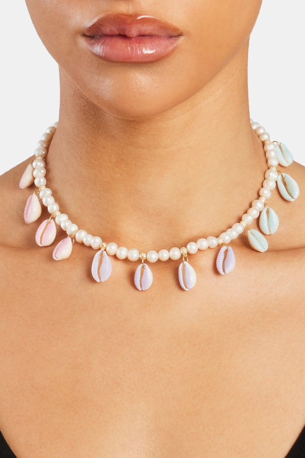 Female model wearing Freshwater Pearl Pastel Cowrie Shell Necklace in gold
