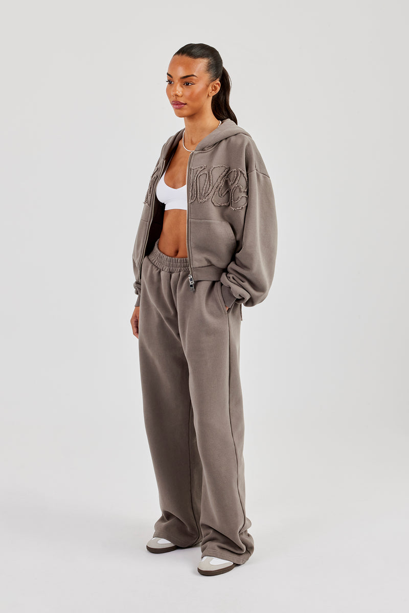 Jogginghose mit weitem Bein und Applikationslogo (verwaschen) – Grau